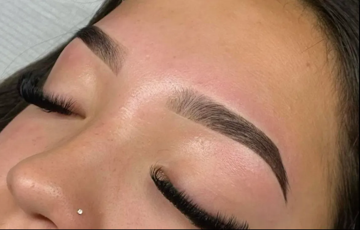 Close-up of a freshly shaped, tinted brow with lash extensions