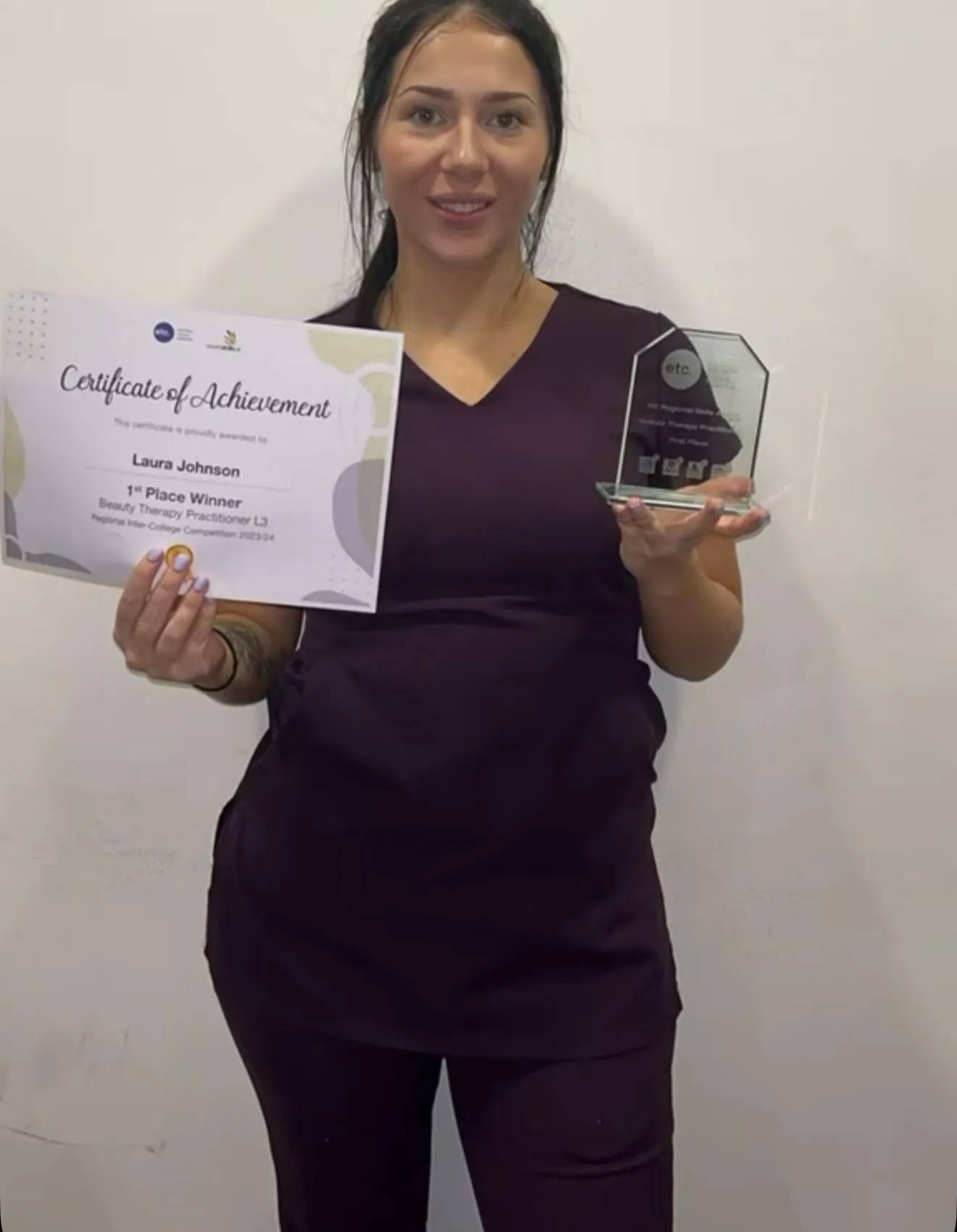 Laura holding her first-place certificate and trophy