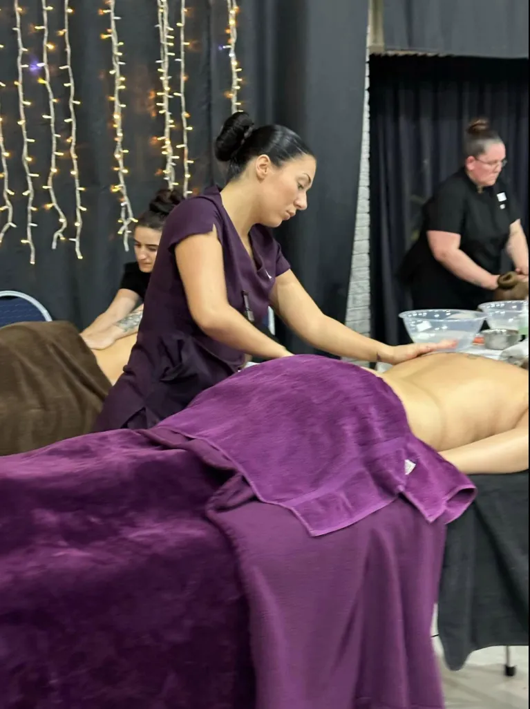 Laura giving a back massage at a national massage competition